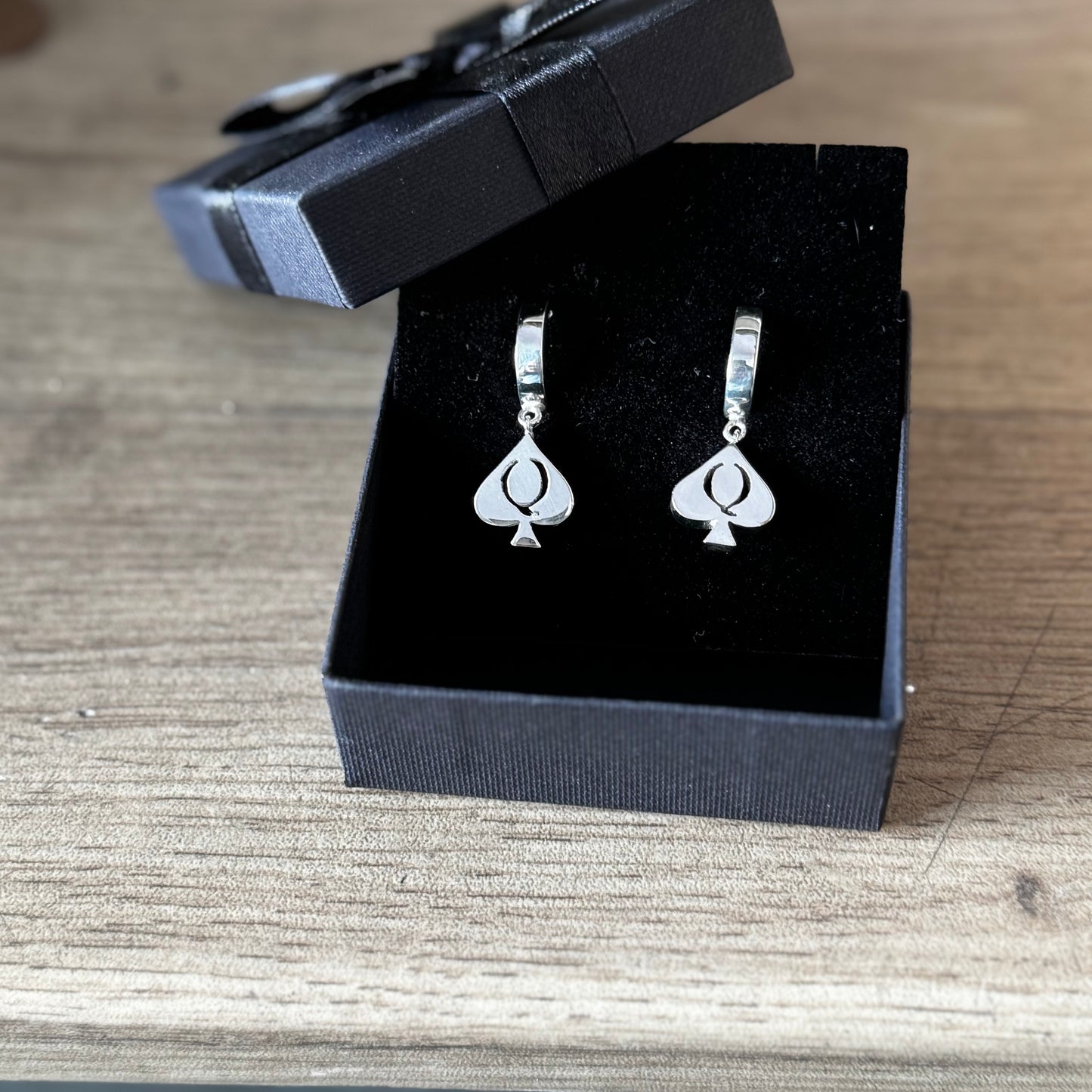 QoS earrings in silver